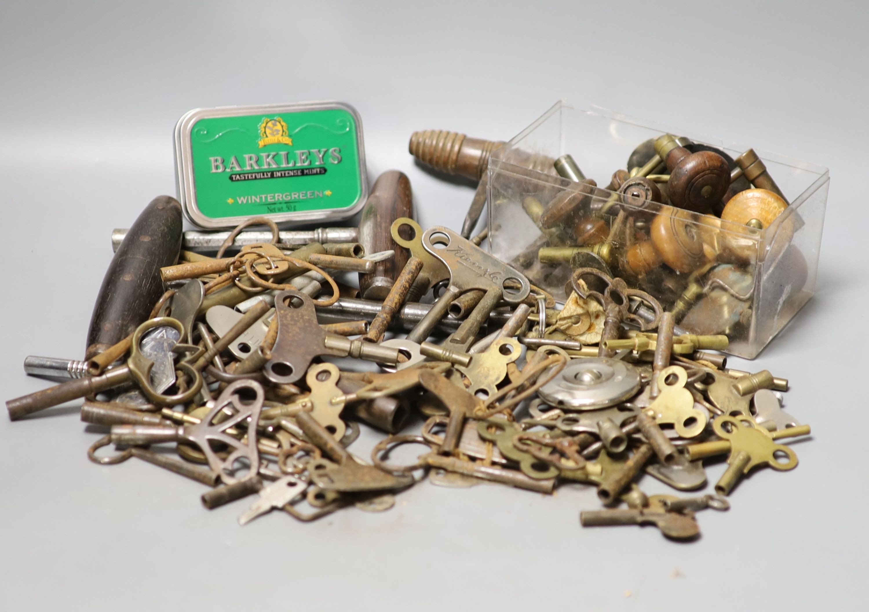 Assorted watch keys and winders and a corkscrew